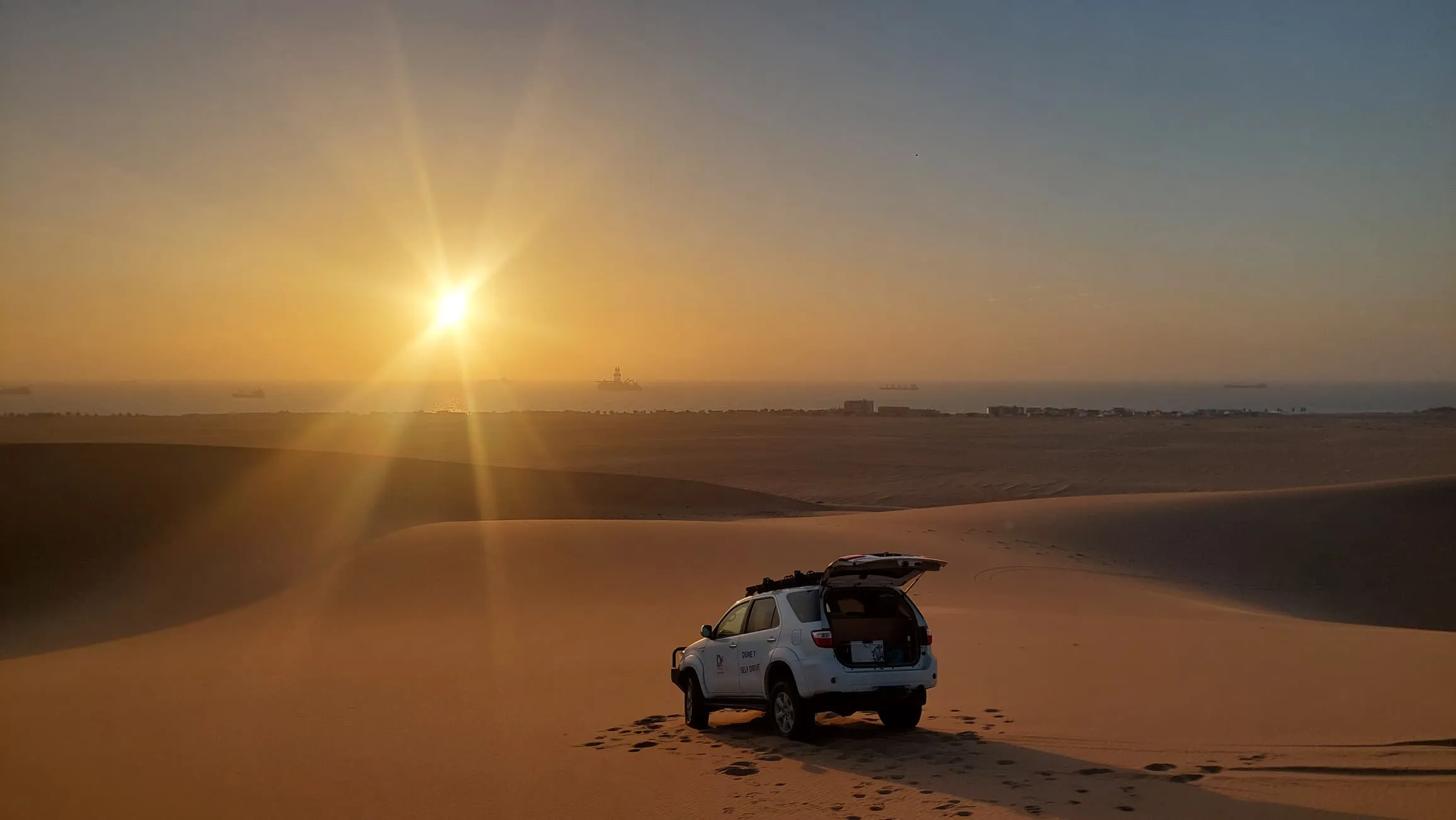 Vast expanse of red sand dunes stretching to the ocean at Sandwich Harbour