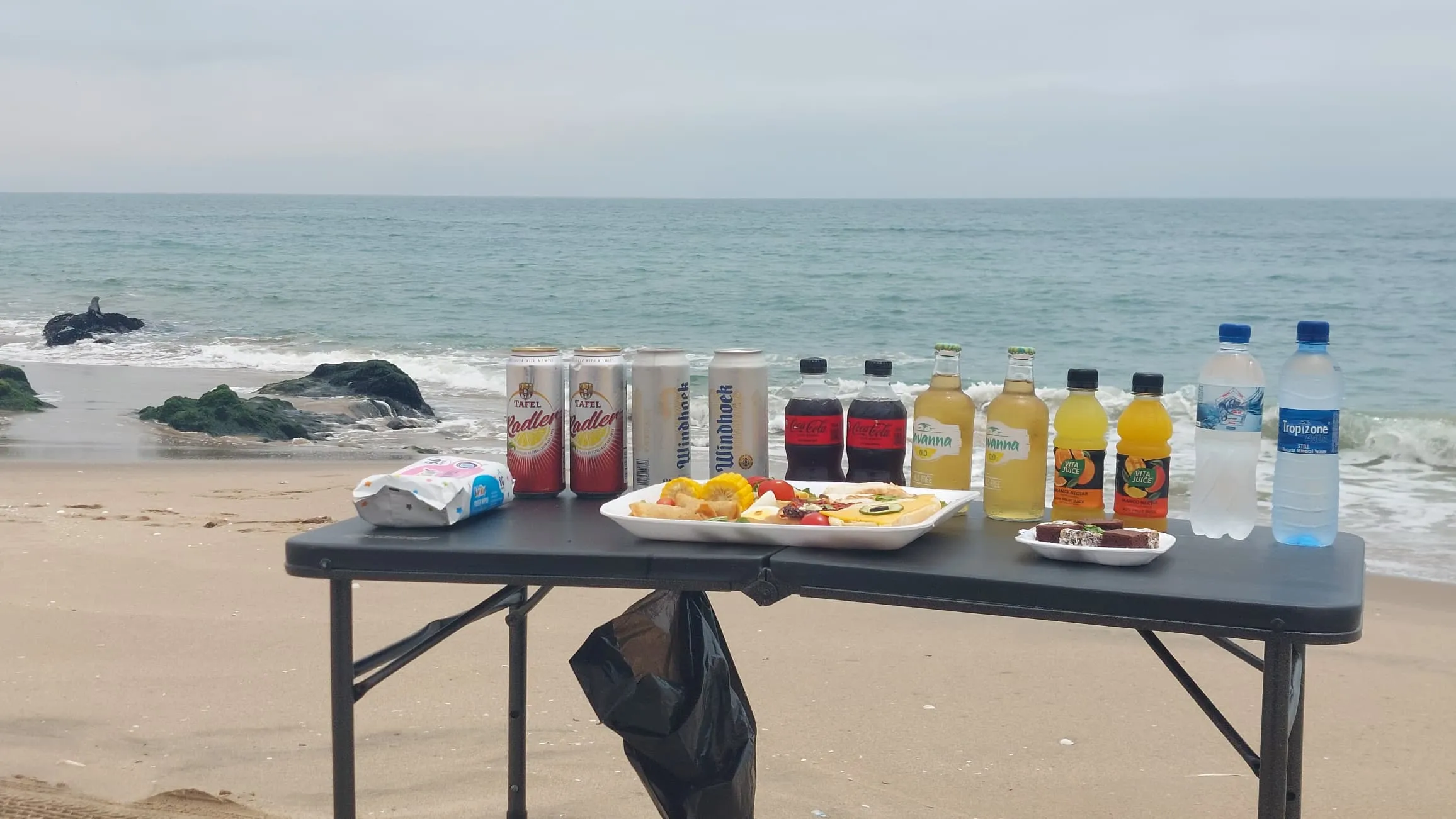 Tour group exploring the dramatic landscape where desert meets sea in Namibia