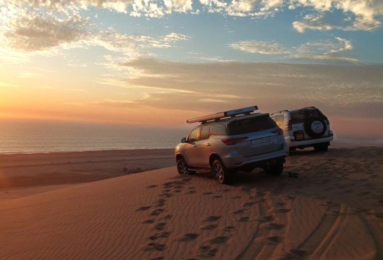 Scenic view of Sandwich Harbour dunes meeting the Atlantic Ocean in Namibia, perfect for dune tours