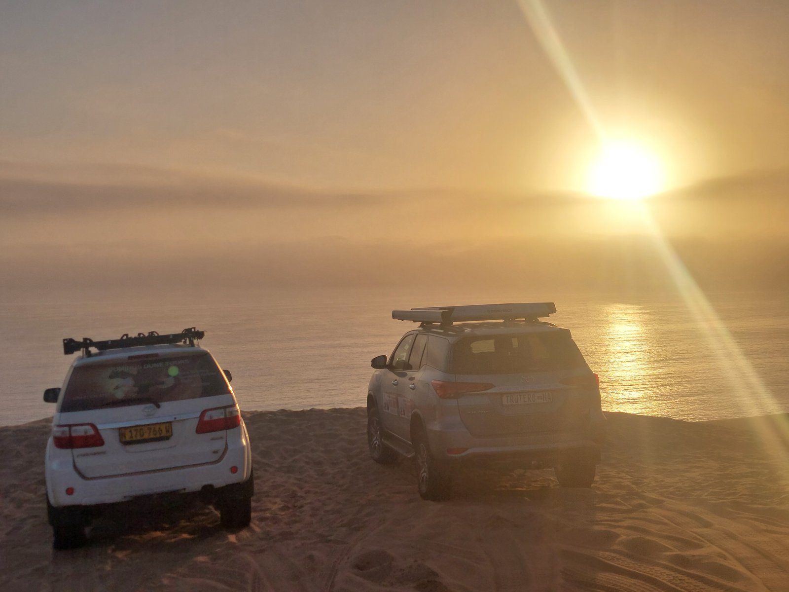 Sandwich Harbour's iconic red dunes and blue ocean meeting point